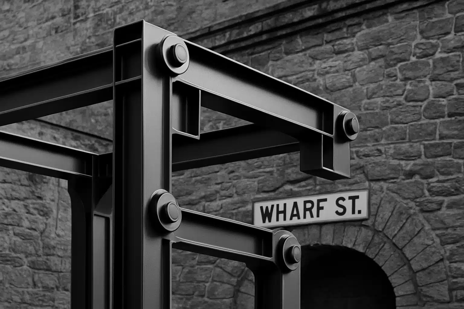 Steel framework against stone wall on Wharf Street in Victoria.